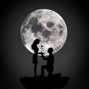 Silhouette of a man proposing to a woman with a giant full moon in the background
