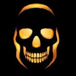 A glowing ember skull in rich shades of orange and gold, radiating warmth and danger from a pitch-black background.