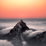 A solitary mountain peak rising above the clouds at sunrise, bathed in soft pastel hues