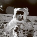 Astronaut on the moon holding a camera, captured in a LED Box Frame design.