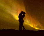 Couple silhouette against the Northern Lights in a romantic moment, perfect for LED Box Frames.