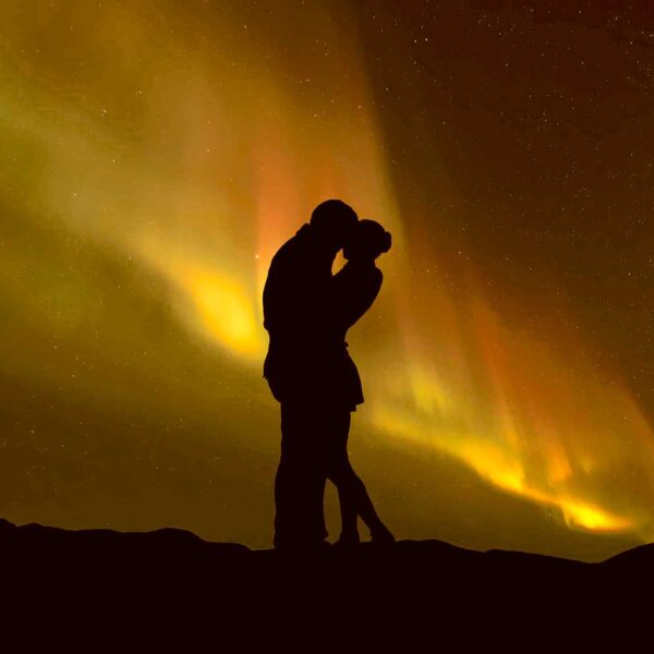 Couple silhouette against the Northern Lights in a romantic moment, perfect for LED Box Frames.