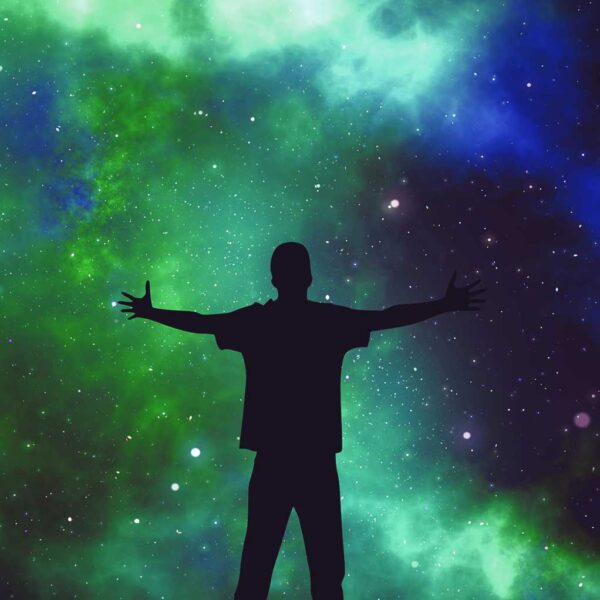 Person with arms outstretched standing against a vibrant cosmic space backdrop, captured in an LED Box Frame.