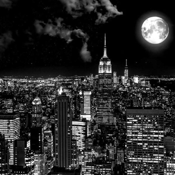 New York City skyline at night with a full moon glowing above the Empire State Building